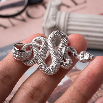 Snake Pendant in 18K White Gold Plated White Bronze, held in hand with the coiled body and head visible.
