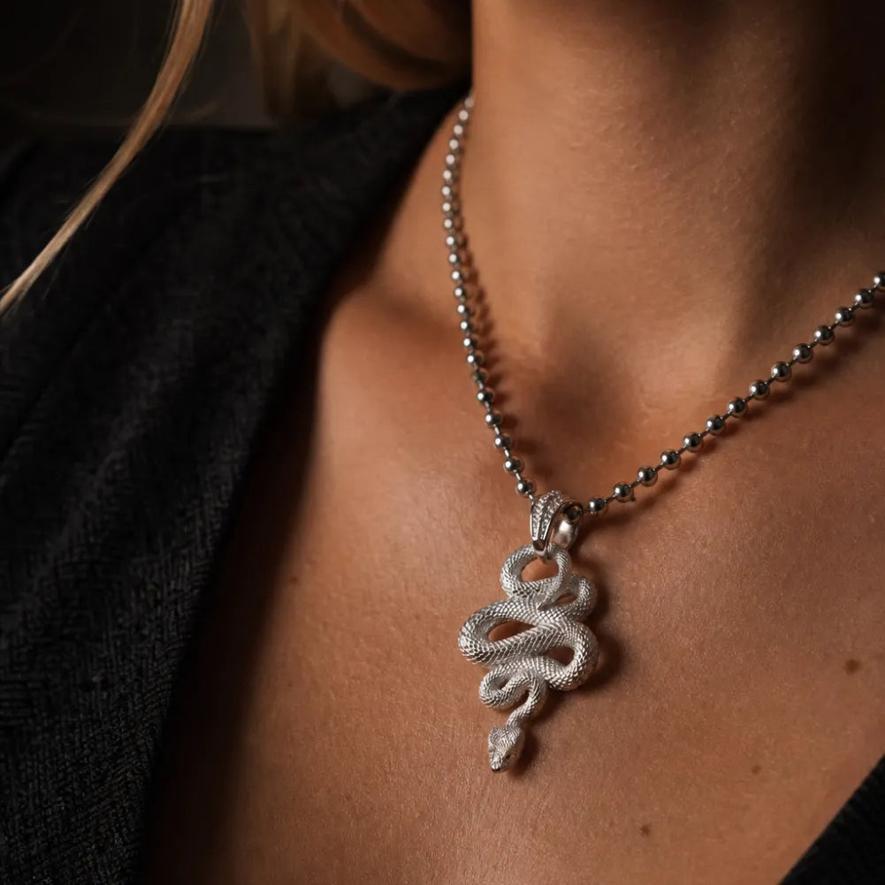 Snake Pendant in 18K White Gold Plated White Bronze, worn as a necklace in a close chest view.