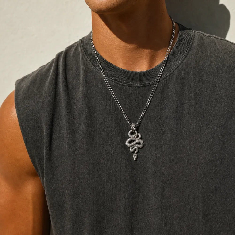 Snake Pendant in White Bronze, worn as a necklace in an outdoor portrait.