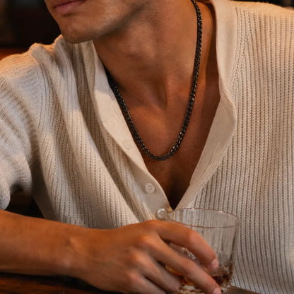 Black stainless steel Cuban chain necklace worn with a light shirt