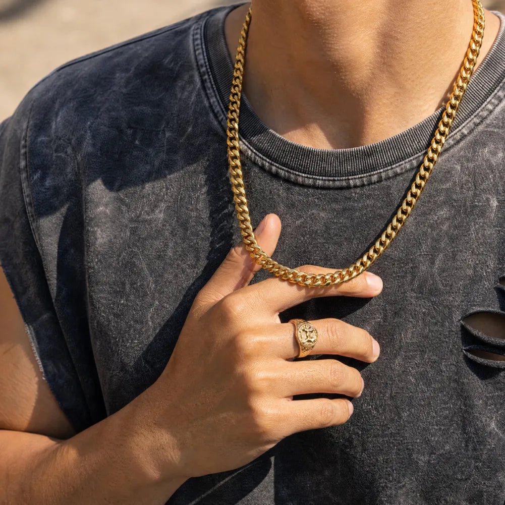 Gold-color stainless steel Cuban chain necklace worn with a dark T-shirt