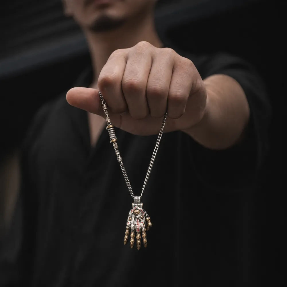 Taoist Mechanical Hand Pendant necklace held in hand