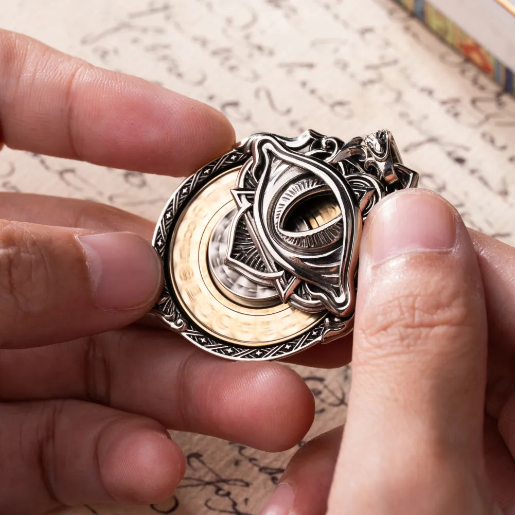 Spinning Tarot Vision Pendant held between fingers