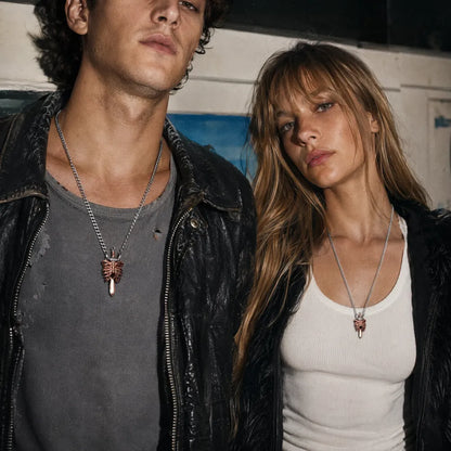 Copper and white bronze Beating Heart Pendant necklaces worn by a couple