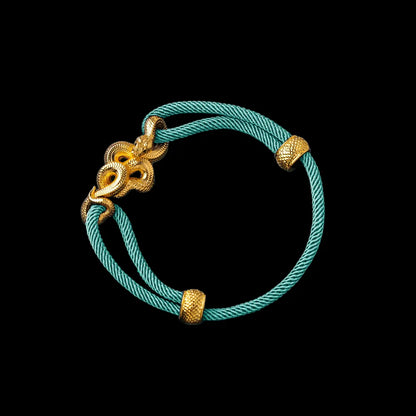 Tree Boa rope bracelet in 24K Gold Plated Brass with 4mm Milan Rope and Light Blue cord, black-background variant view