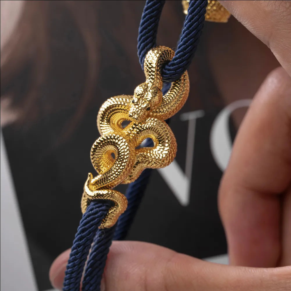 Tree Boa Rope Bracelet in 24K Gold Plated Brass, held in hand with the complete rope bracelet visible.