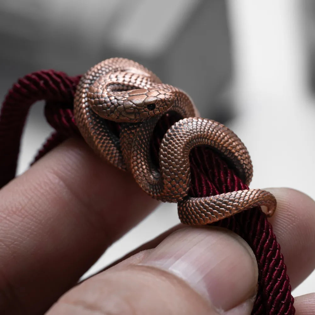 Copper Tree Boa rope bracelet held in hand showing scale texture